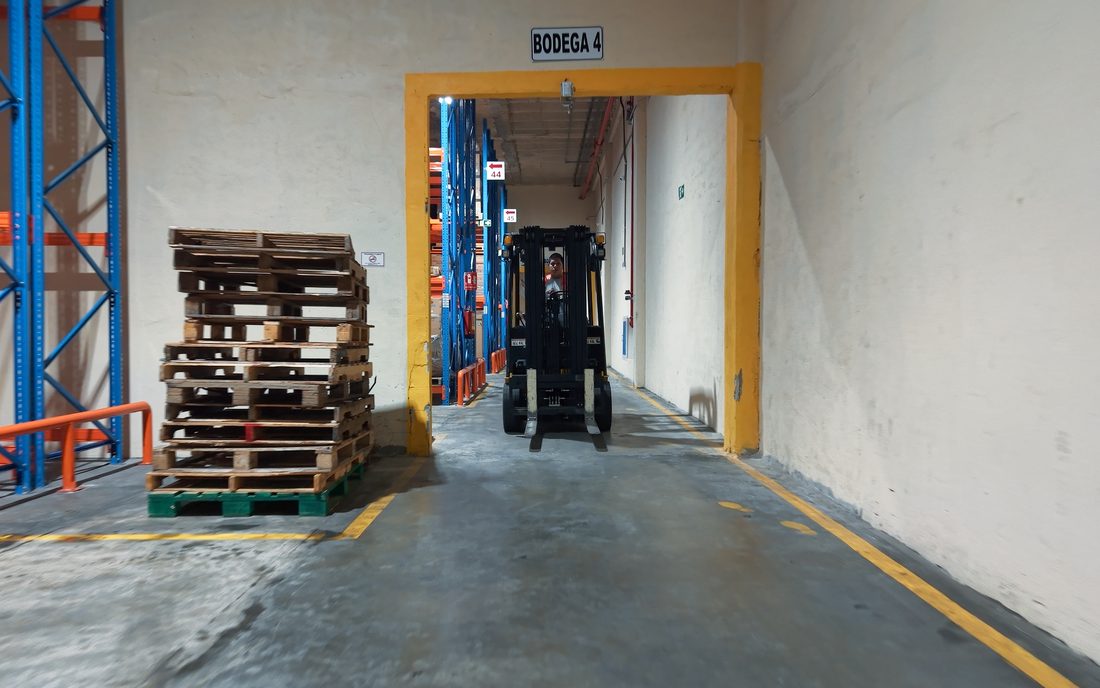 Entrance to Warehouse 4 with pallets and a forklift in transit