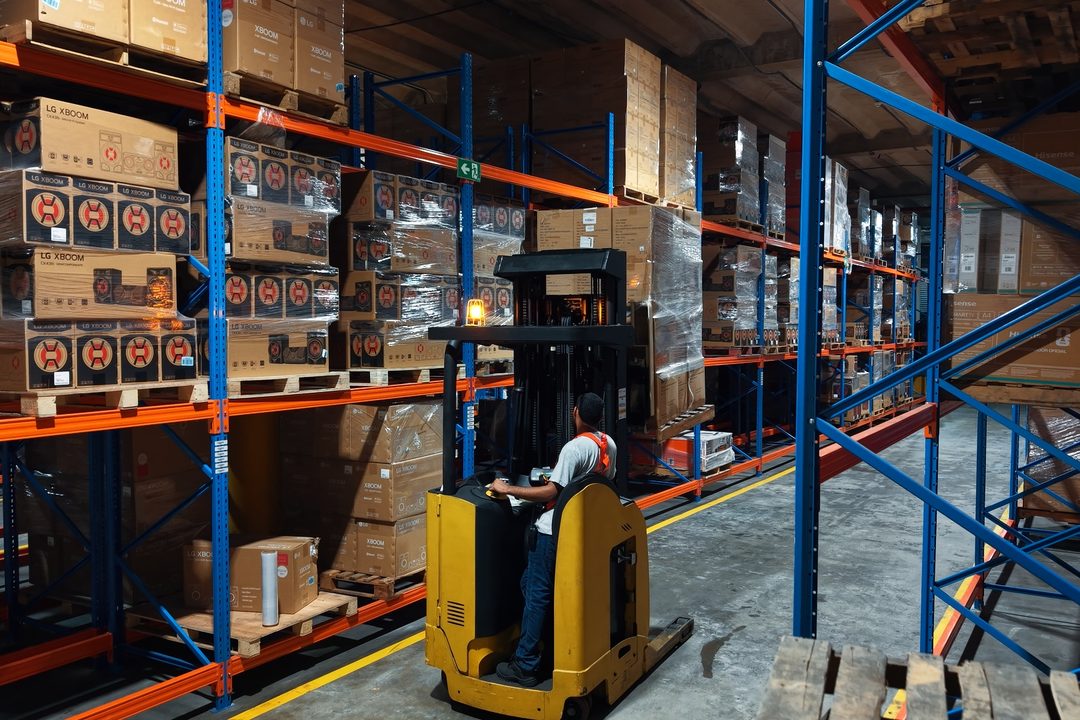 Storage racking with inventory and a reach truck in operation