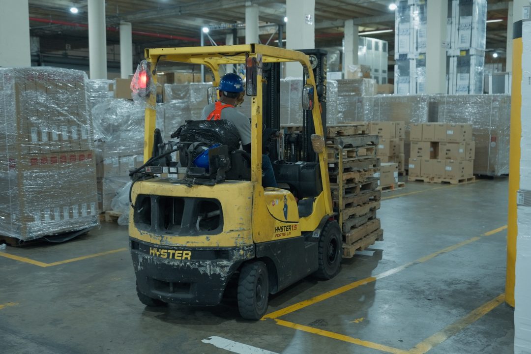 Forklift moving pallets inside the warehouse