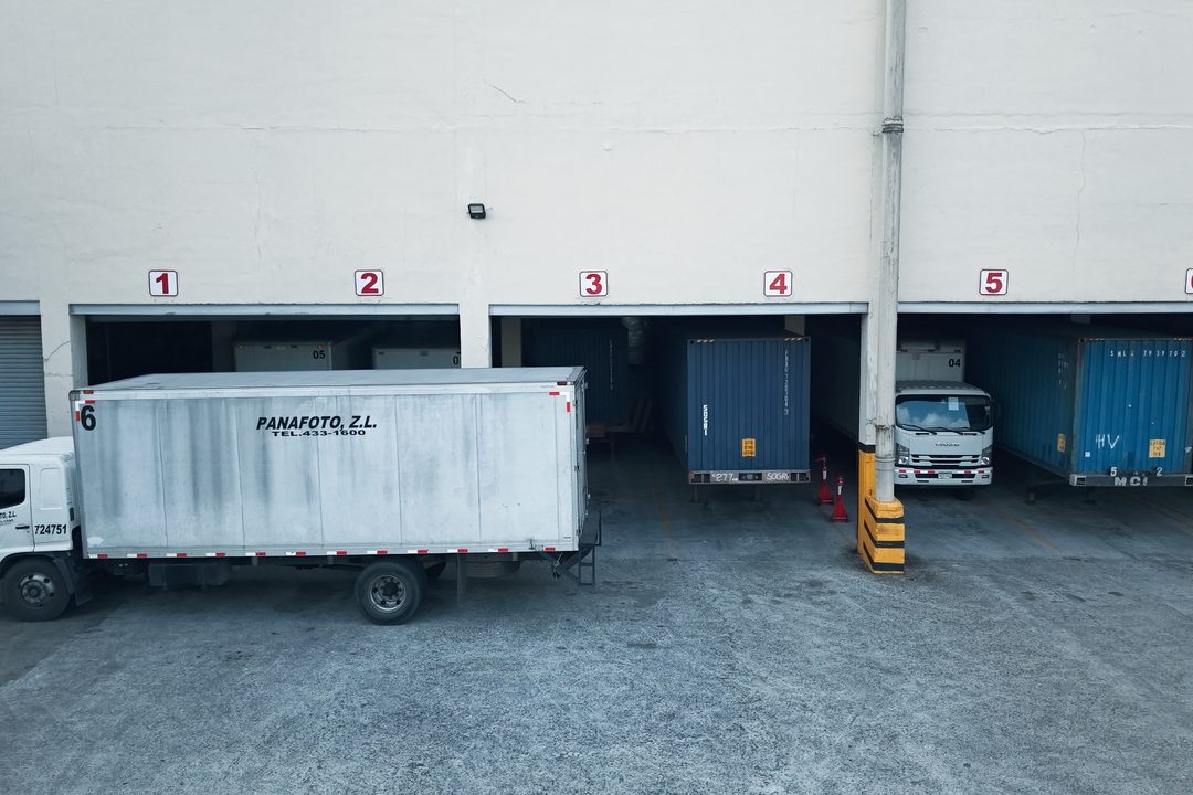 Numbered Ashram Logistics docks with containers positioned for unloading