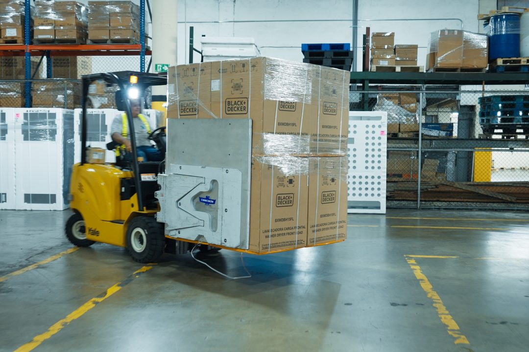 Clamp forklift moving palletized goods
